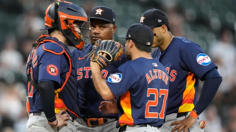 Houston Astros second baseman Jose Altuve (27) talks to starting...