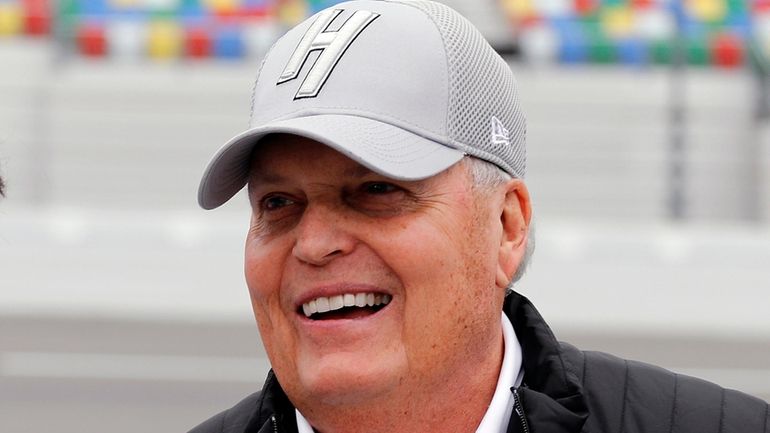 NASCAR team owner Rick Hendrick laughs on pit road during...