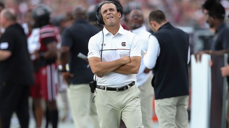 South Carolina head coach Shane Beamer checks the scoreboard after...