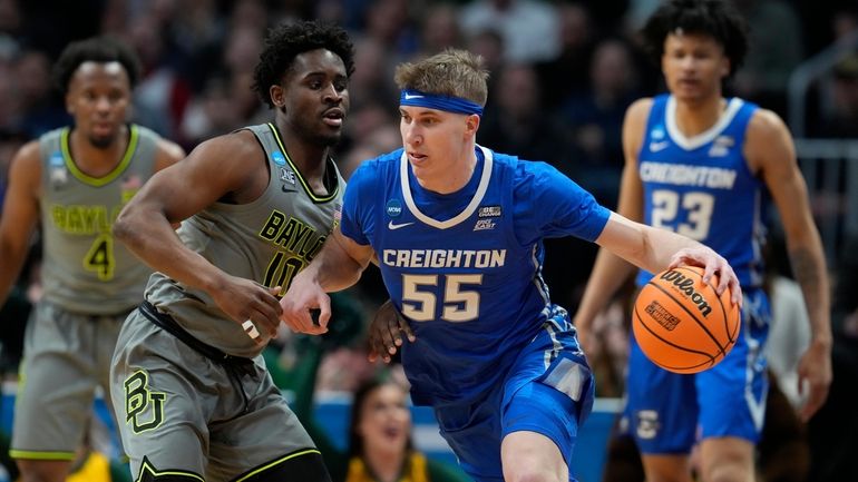 Creighton guard Baylor Scheierman, right, drives past Baylor guard Adam...