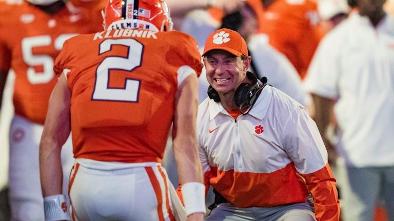 Clemson head coach Dabo Swinney, front right, celebrates with quarterback...