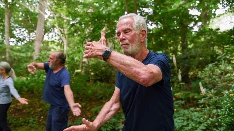 Don Lenzer moves through an introductory Tai Chi class held...