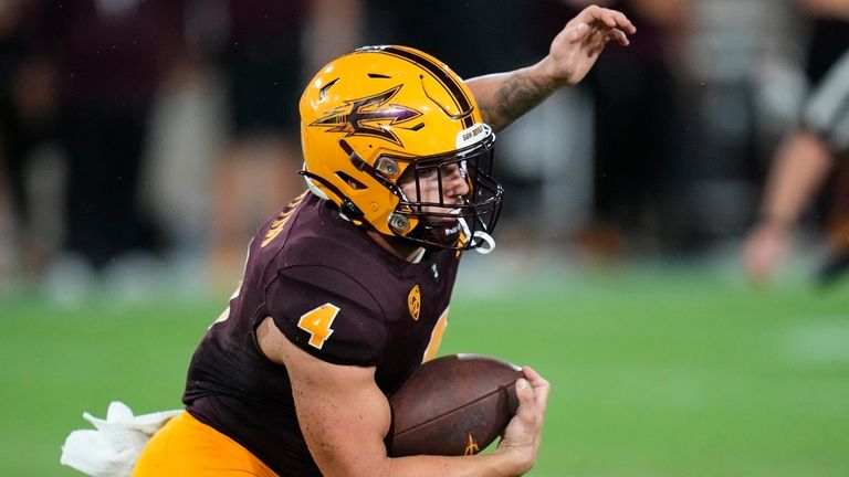 Arizona State running back Cameron Skattebo runs with the ball...