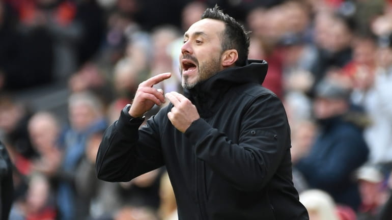 Brighton's head coach Roberto De Zerbi shouts to his players...