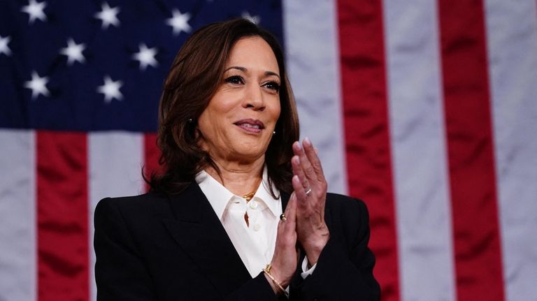 Vice President Kamala Harris stands ahead of President Joe Biden's third...