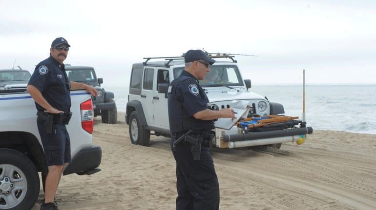 Police respond to Amagansett's Truck Beach in June when a group drove their...