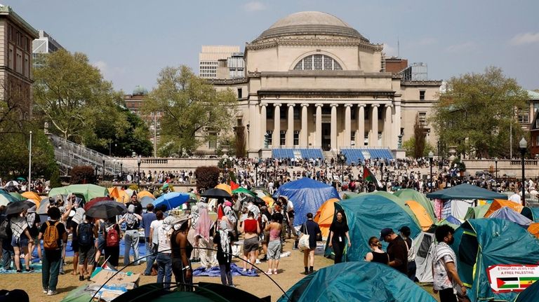 Student protesters gather inside their encampment on the Columbia University...