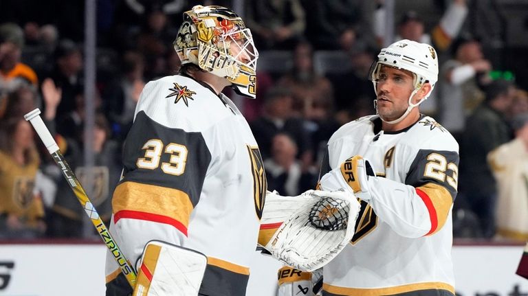 Vegas Golden Knights defenseman Alec Martinez (23) celebrates with goaltender...