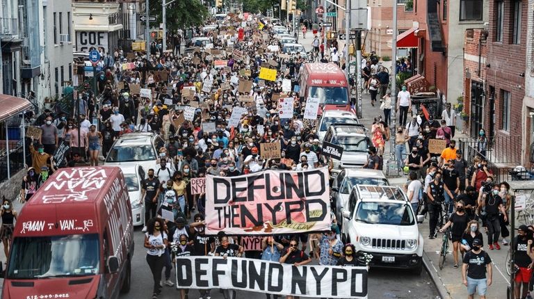 Protesters march Sunday on Driggs Avenue in Williamsburg.