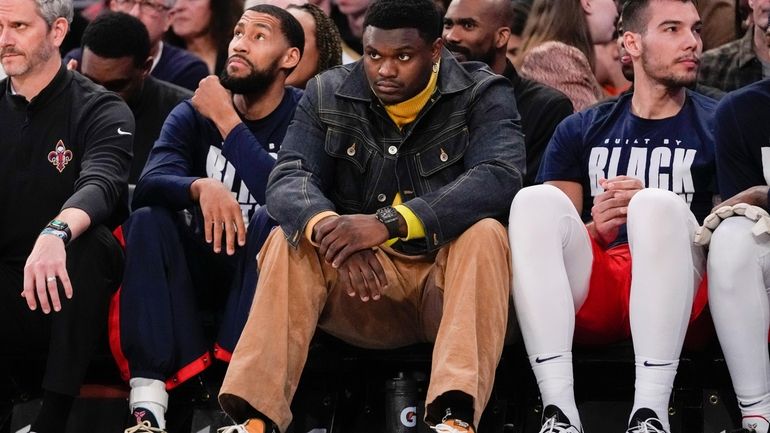 New Orleans Pelicans forward Zion Williamson, center watches from the...