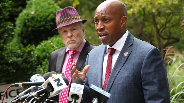 Suffolk Police Commissioner Rodney K. Harrison, right, speaks at a...