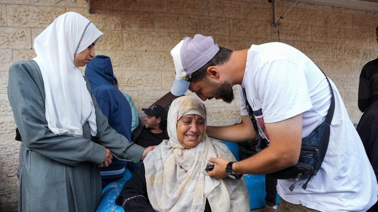 Palestinians mourn their relatives killed during Israeli airstrikes in the...