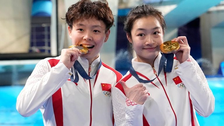 China's Chen Yiwen and Chang Yani hold their gold medal...