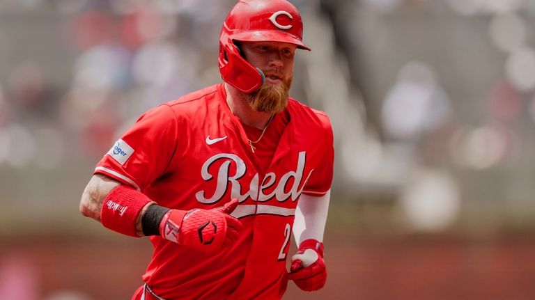 Cincinnati Reds' Jake Fraley rounds second base after hitting a...