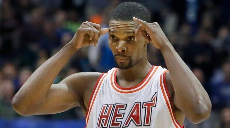 Miami Heat forward Chris Bosh reacts to a call during...