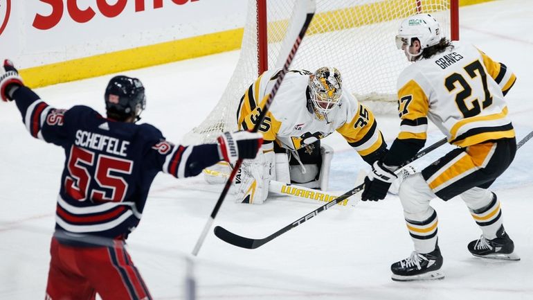 Winnipeg Jets' Mark Scheifele (55) celebrates his goal against Pittsburgh...