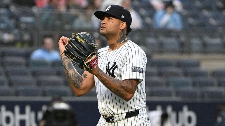 Yankees starting pitcher Luis Gil walks to the dugout after...