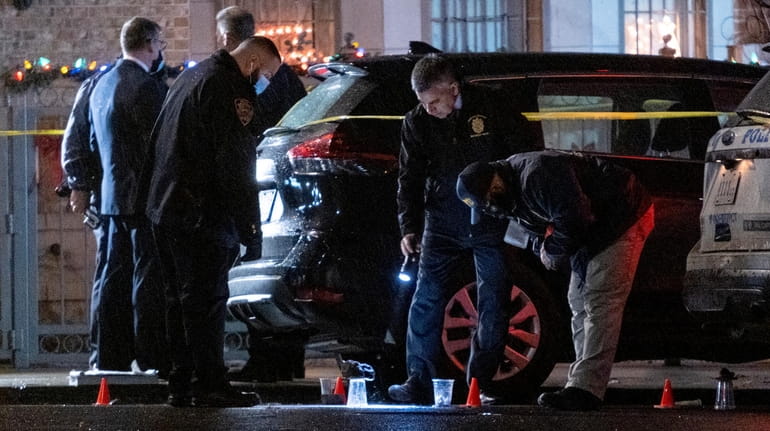 NYPD investigators at the scene in Crown Heights, Brooklyn, of...