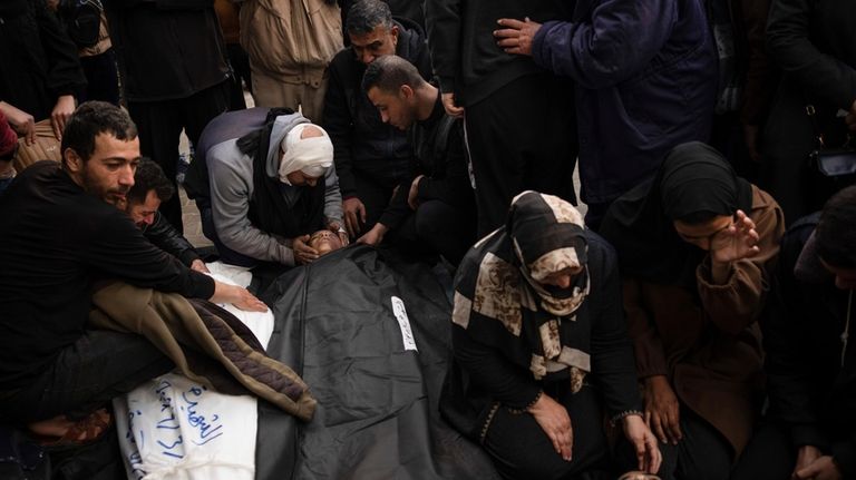 Palestinians mourn relatives killed in the Israeli bombardment of the...