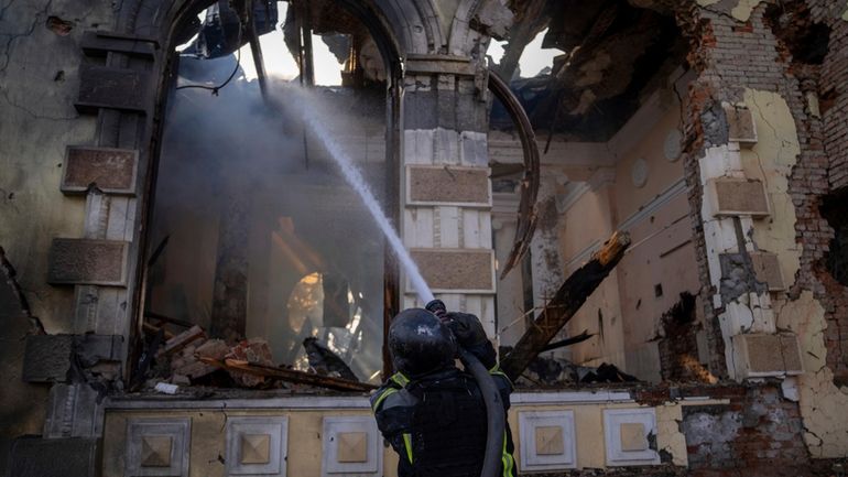 Firefighters put out the fire a railway station after Russians...