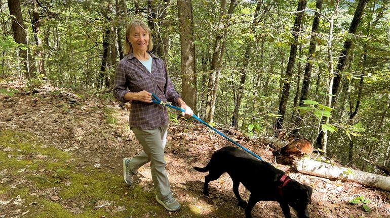 Susannah Johnston, of Croton-on-Hudson, N.Y., walks her dog. Johnston on...