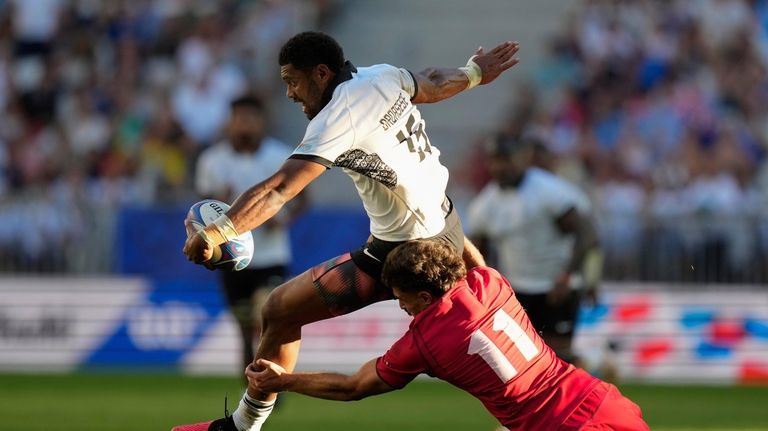 Fiji's Ilaisa Droasese is tackled by Georgia's Davit Niniashvili during...