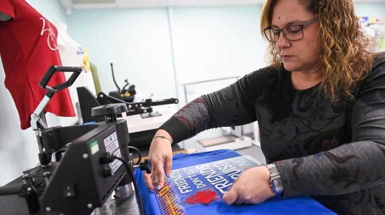 Amy Blum, of Merrick, makes a T-shirt for an upcoming...