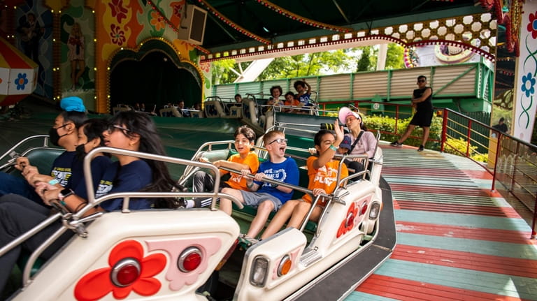 Kids ride amusement park rides at Adventureland in Farmingdale, New...