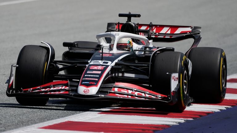 Haas driver Kevin Magnussen of Denmark steers his car at...