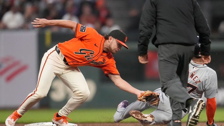 San Francisco Giants second baseman Brett Wisely, left, tags out...