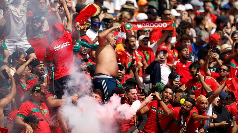 Morocco supporters celebrate after Soufiane Rahimi scored the opening goal...