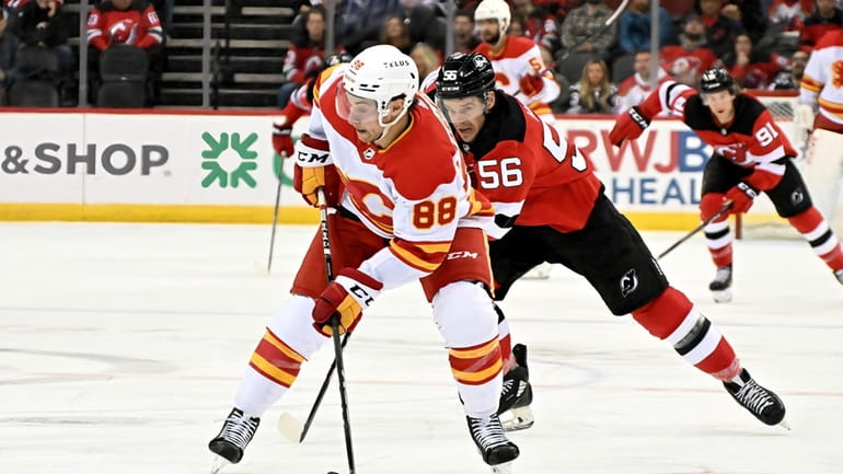 Calgary Flames left wing Andrew Mangiapane (88) handles the puck...