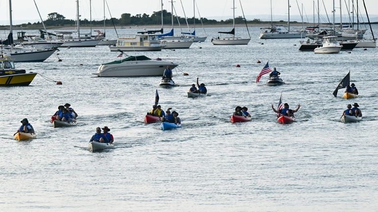 Veterans and first responders paddle into Port Jefferson Harbor on...