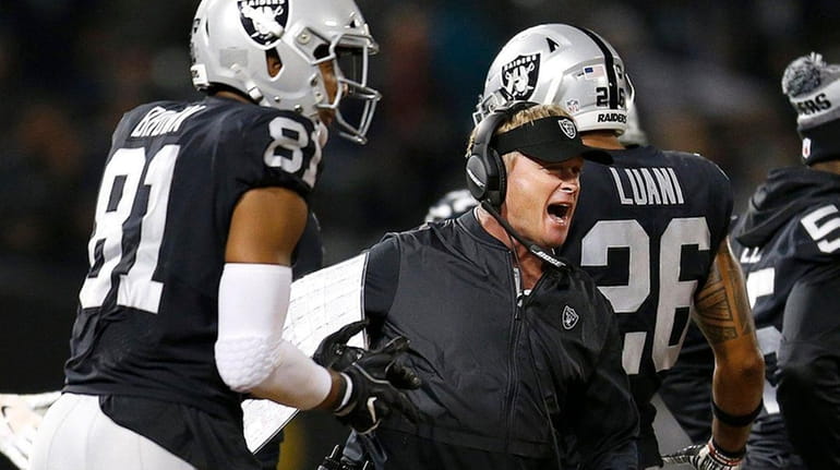 Oakland Raiders head coach Jon Gruden celebrates with players during...