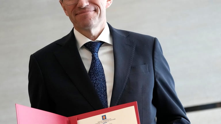 Norway's Foreign Minister Espen Barth Eide shows a document which...