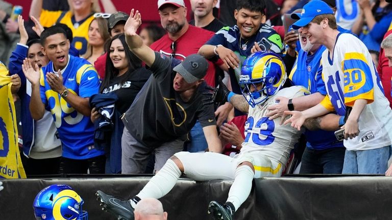 Los Angeles Rams running back Kyren Williams celebrates with fans...