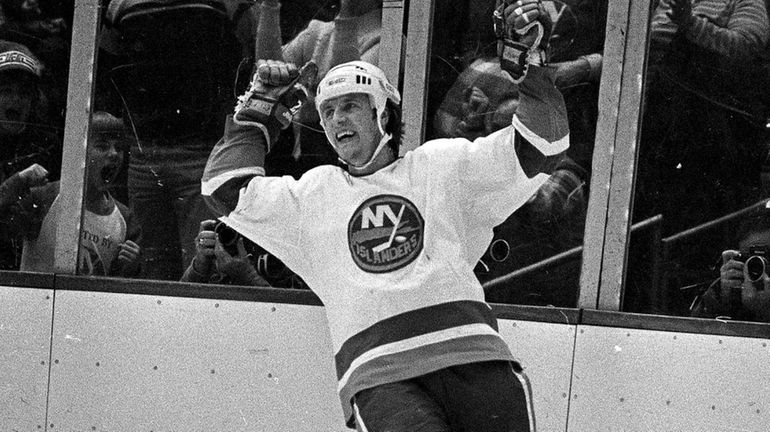 Islanders winger Mike Bossy cheers after his hat trick goal...