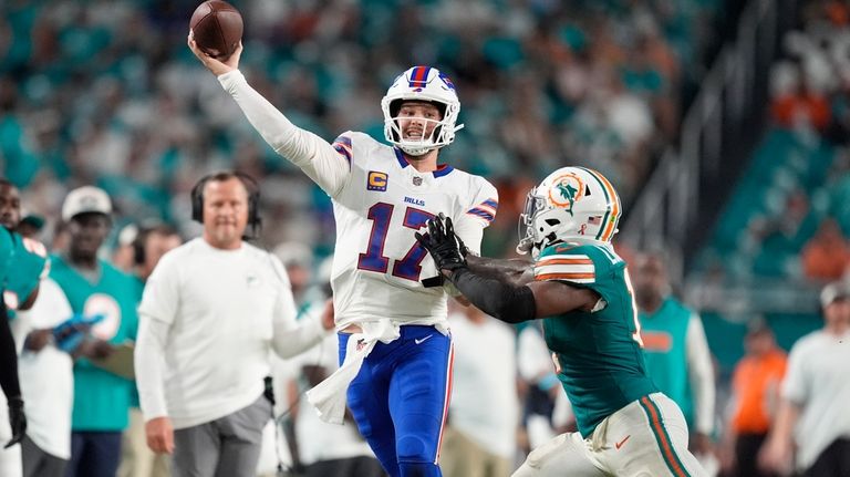 Buffalo Bills quarterback Josh Allen (17) aims a pass under...