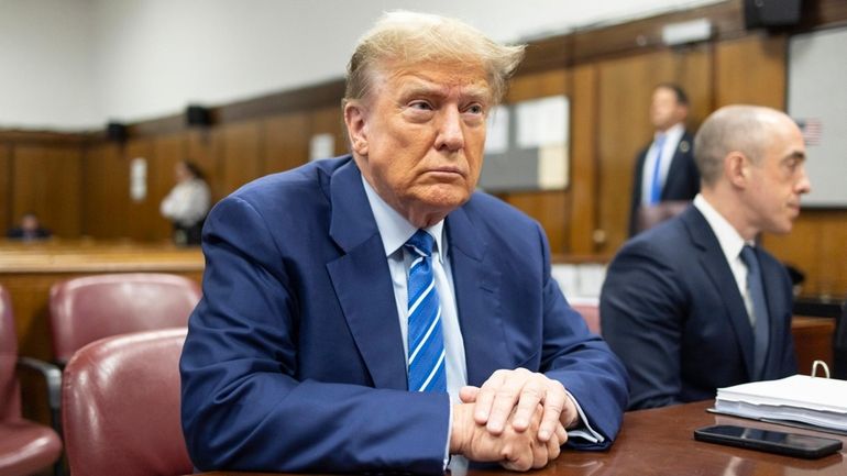 Former President Donald Trump awaits the start of proceedings at...