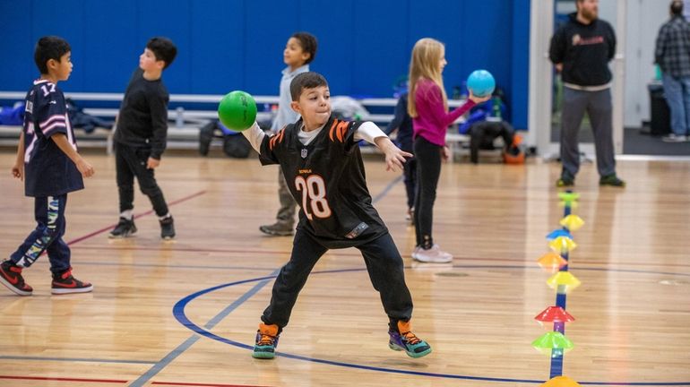 Wyatt Boller, 7, from Melville throws a ball during a...