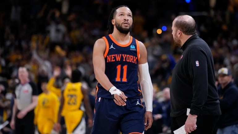 Knicks guard Jalen Brunson walks to the bench during a timeout...