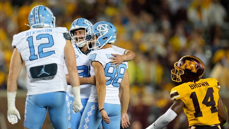 North Carolina place kicker Noah Burnette (98) celebrates with teammates...