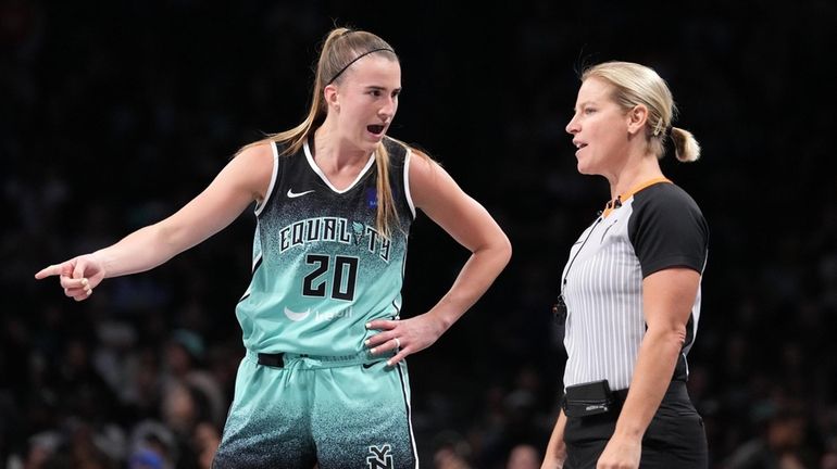 Sabrina Ionescu of the Liberty talks to the official after...