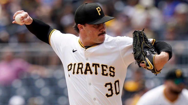 Pittsburgh Pirates starting pitcher Paul Skenes delivers during the first...