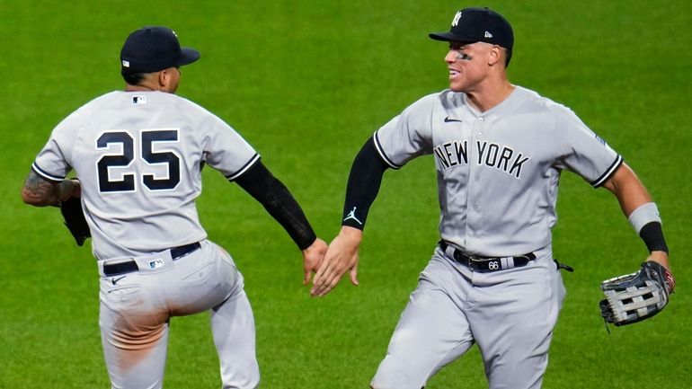 The Yankees' Gleyber Torres celebrates with Aaron Judge after the...