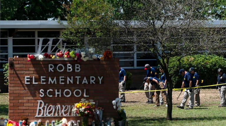 Investigators search for evidences outside Robb Elementary School in Uvalde,...