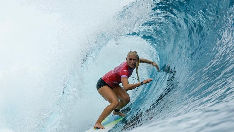 Tatiana Weston-Webb, of Brazil, gets into a barrel during the...