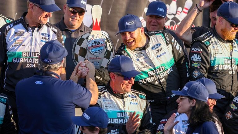 Chris Buescher's (17) team celebrates after winning a NASCAR Cup...