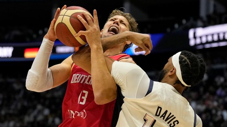 Germany's forward Moritz Wagner, left, is blocked by United States'...