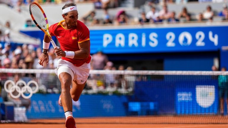 Rafael Nadal of Spain runs for a ball during his...